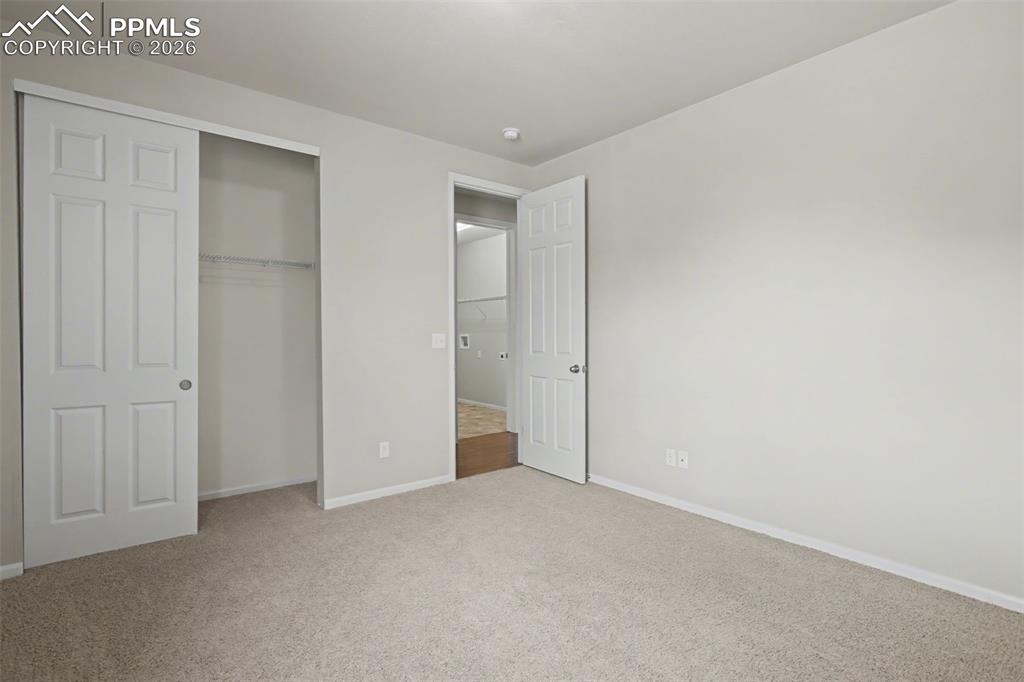Image 24 of 40: Unfurnished bedroom with light colored carpet and a closet