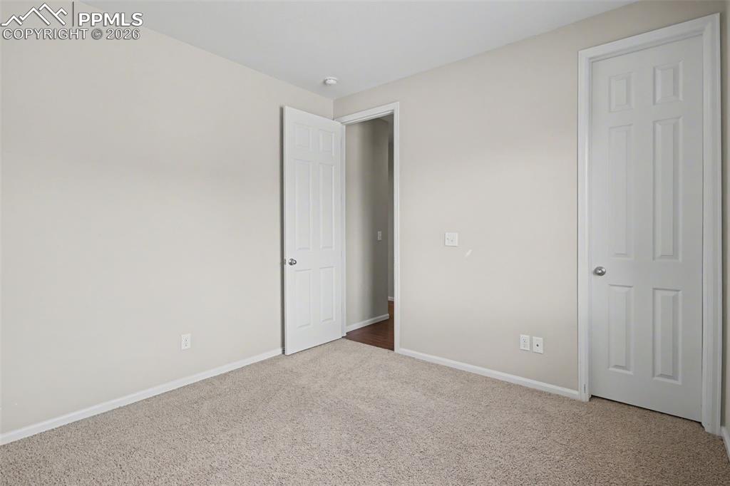 Image 28 of 40: Unfurnished bedroom featuring baseboards and carpet