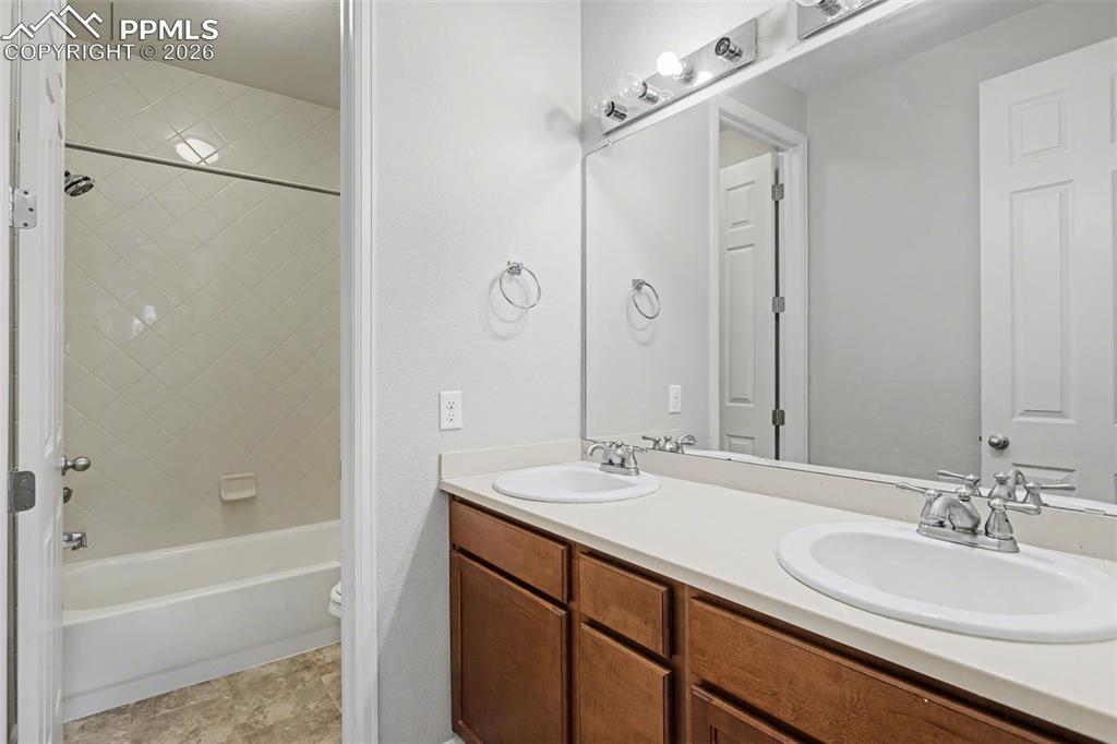 Image 29 of 40: Full bath featuring double vanity and bathtub / shower combination