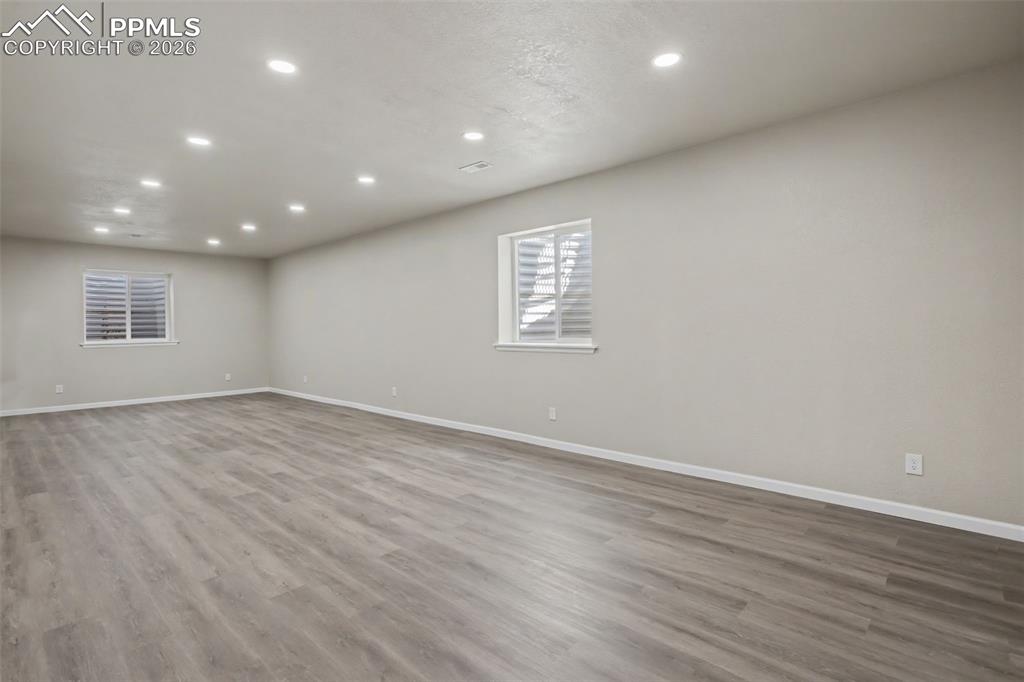 Image 30 of 40: Empty room featuring recessed lighting and dark wood-type flooring