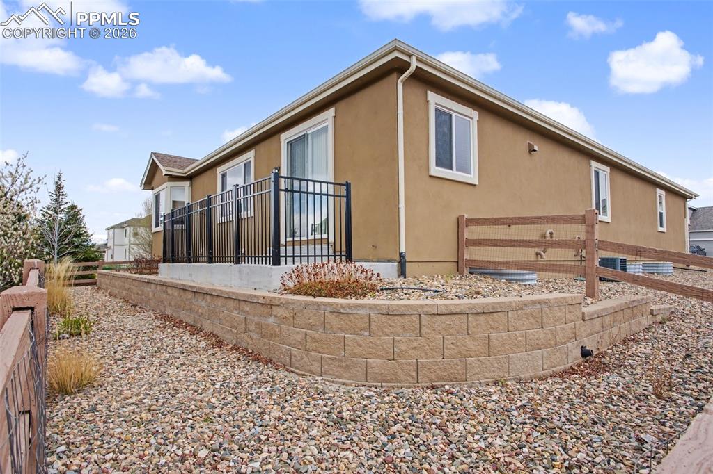 Image 40 of 40: View of side of home with stucco siding