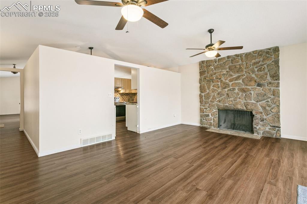Image 14 of 43: The main level family room is accessible from the kitchen and also via a ha