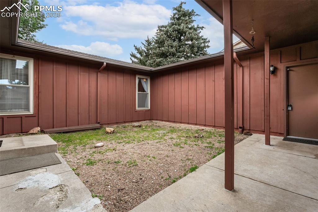 Image 2 of 43: Make this courtyard between the house and garage your outdoor retreat! Priv