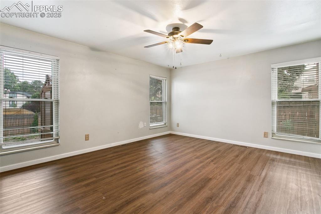 Image 20 of 43: The large primary bedroom is bathed in natural light.