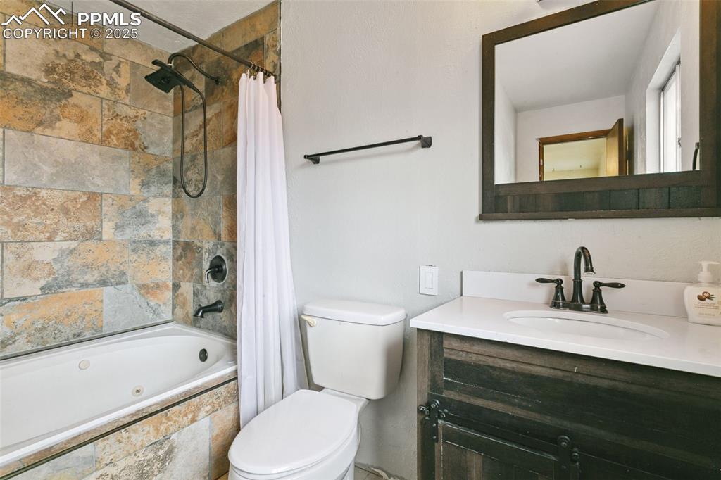 Image 23 of 43: The private primary bath boasts a tiled tub/shower surround and tile floori