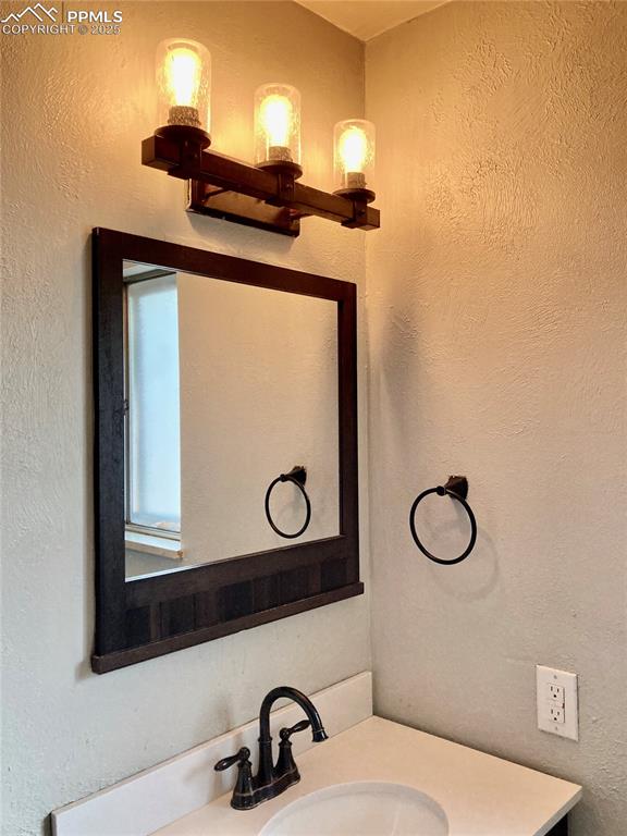 Image 24 of 43: The primary bathroom features upgraded lighting.