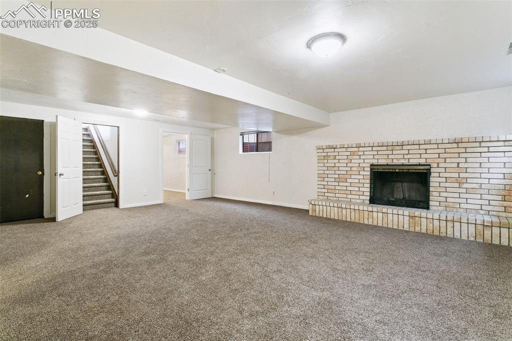 Image 27 of 43: How will you use this huge basement family/rec room with WB fireplace? It
