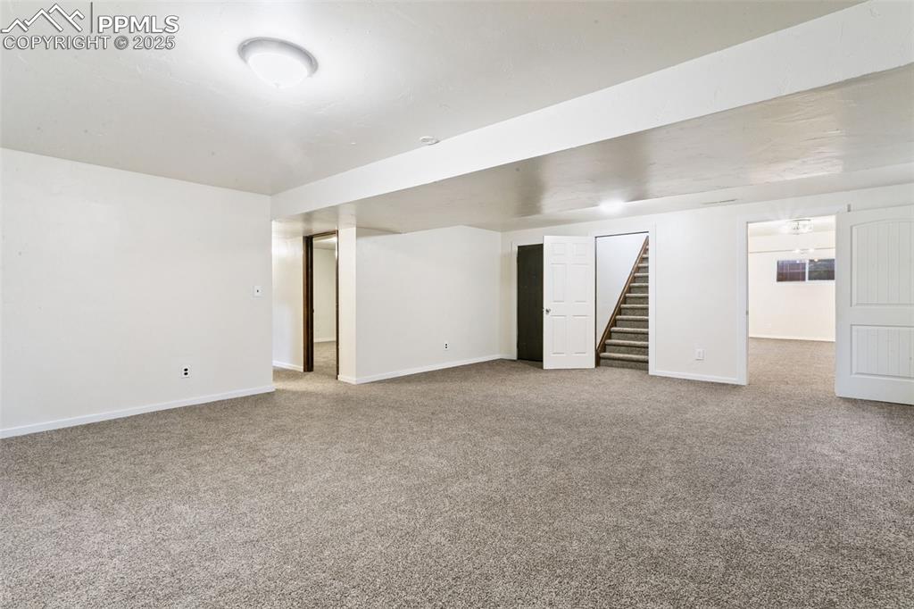 Image 31 of 43: Basement family room leads to a bonus room, 2 additional bedrooms, full bat