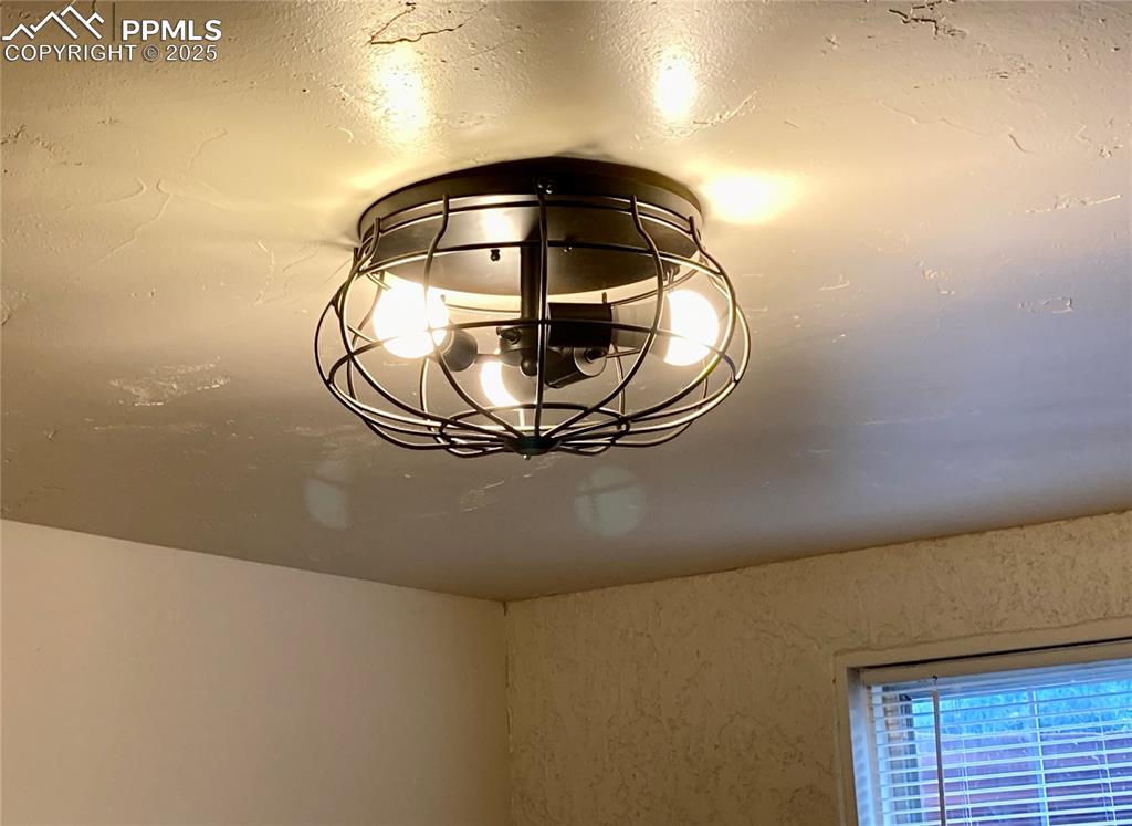 Image 35 of 43: Industrial ceiling light fixture in office/workout room.