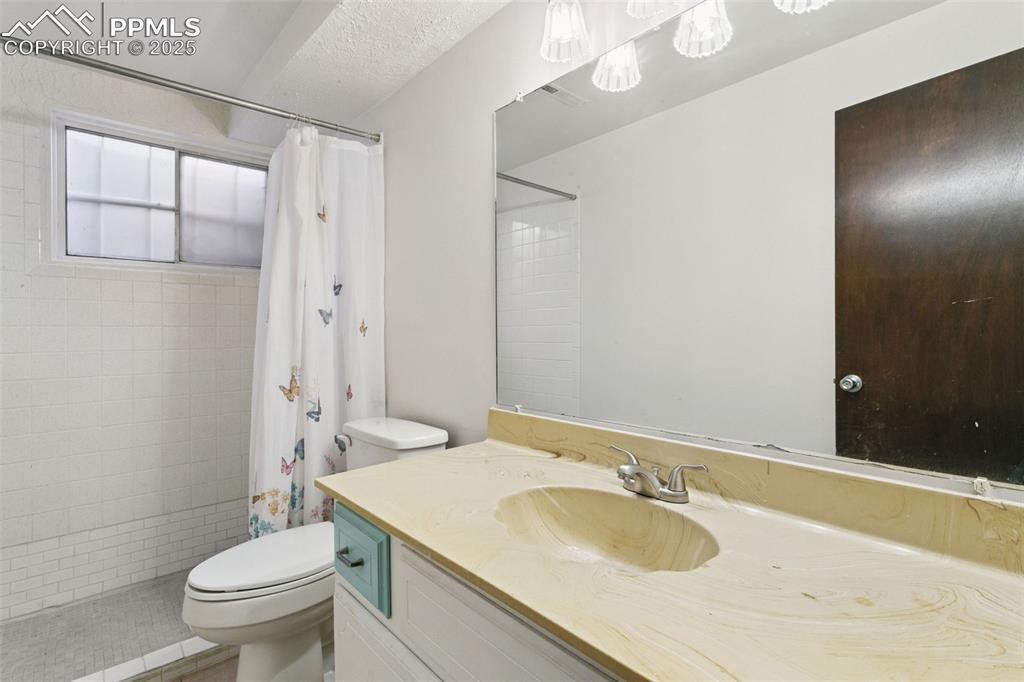 Image 36 of 43: Basement 3/4 bath includes a large, tiled step-in shower.