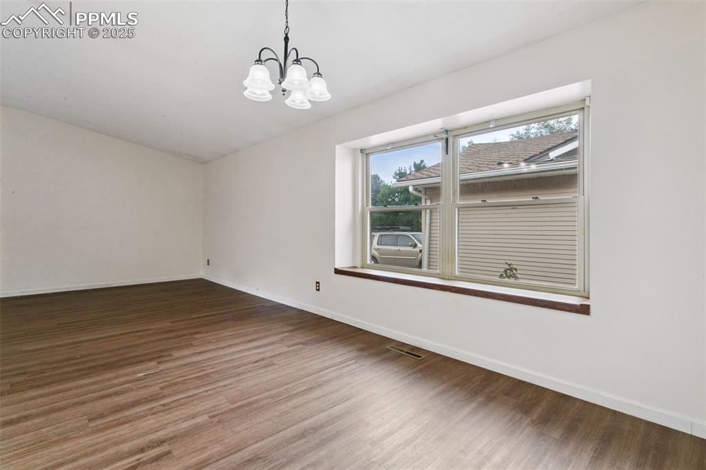 Image 7 of 43: The dining room is awash in natural light from the large window.