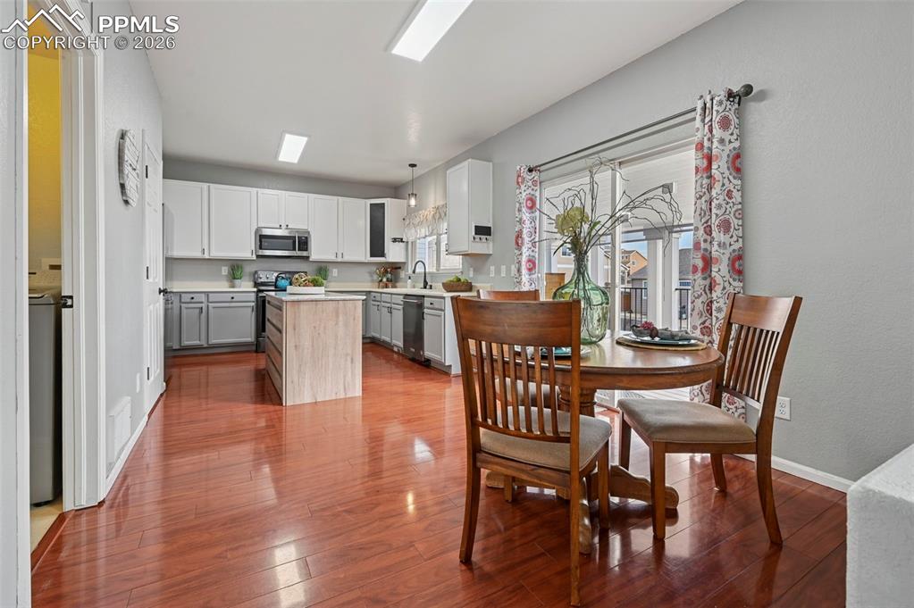 Image 10 of 49: Eat-in kitchen with slider to covered deck