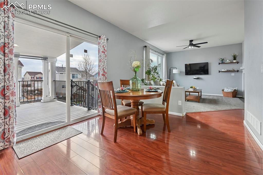 Image 11 of 49: Eat-in kitchen with slider to covered deck