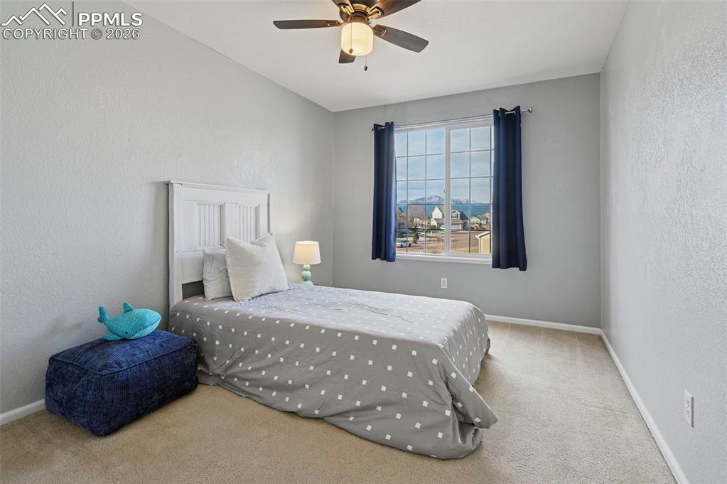 Image 28 of 49: Upstairs, bedroom 3 with west-facing windows and Pikes Peak Views