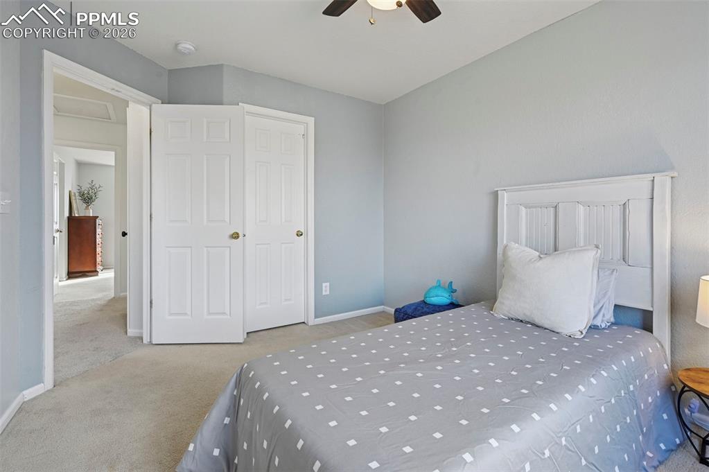 Image 29 of 49: Upstairs, bedroom 3 with west-facing windows, walk-in closet, and Pikes Pea