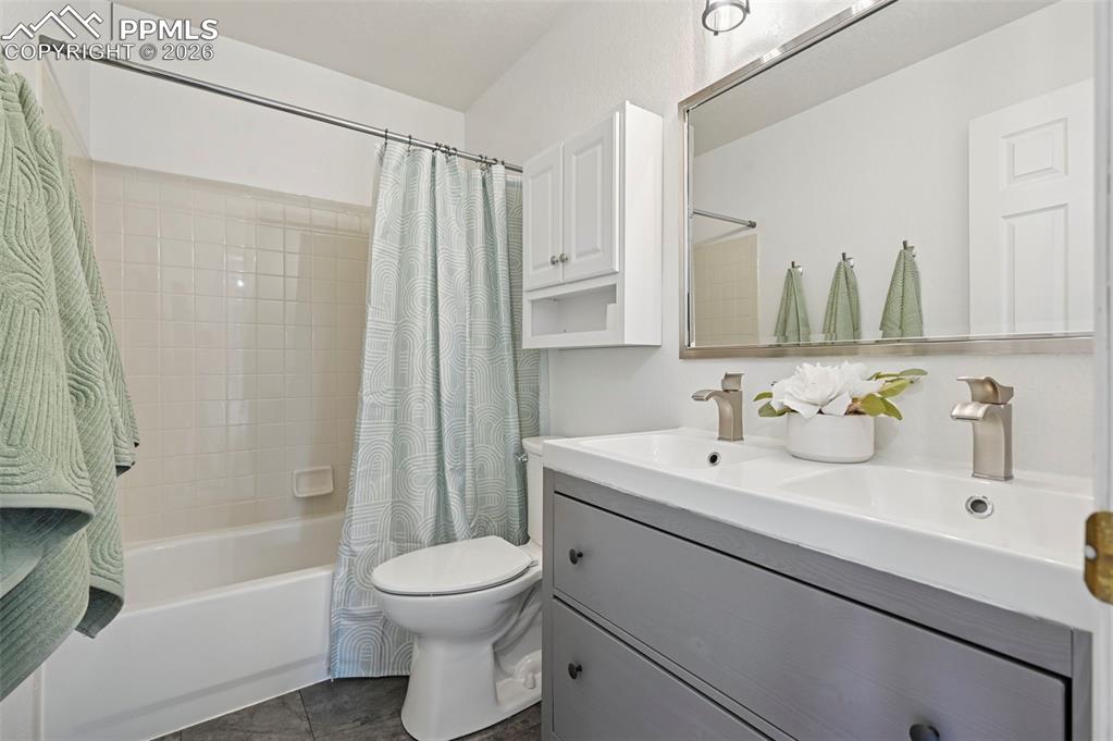 Image 30 of 49: Upstairs full bath with dual vanity