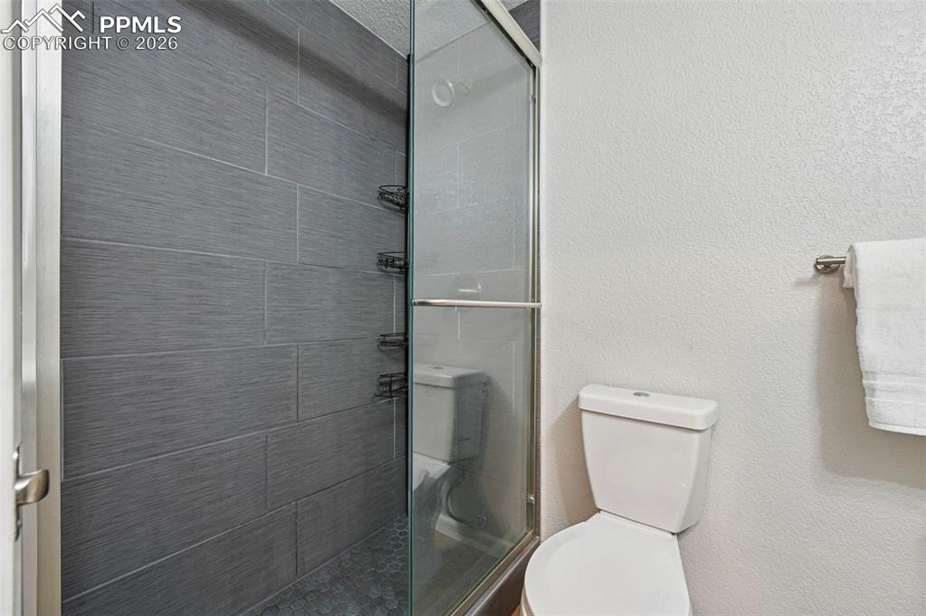 Image 32 of 49: Downstairs bathroom with tiled shower,  completed in 2021