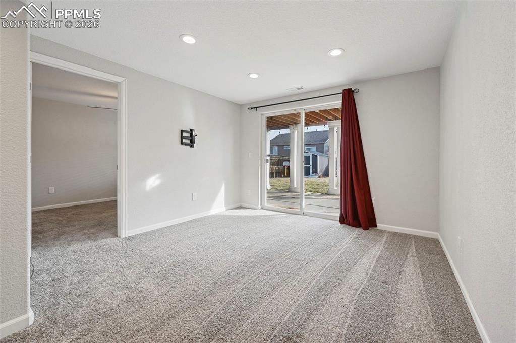 Image 38 of 49: Downstairs living/rec space with walk-out