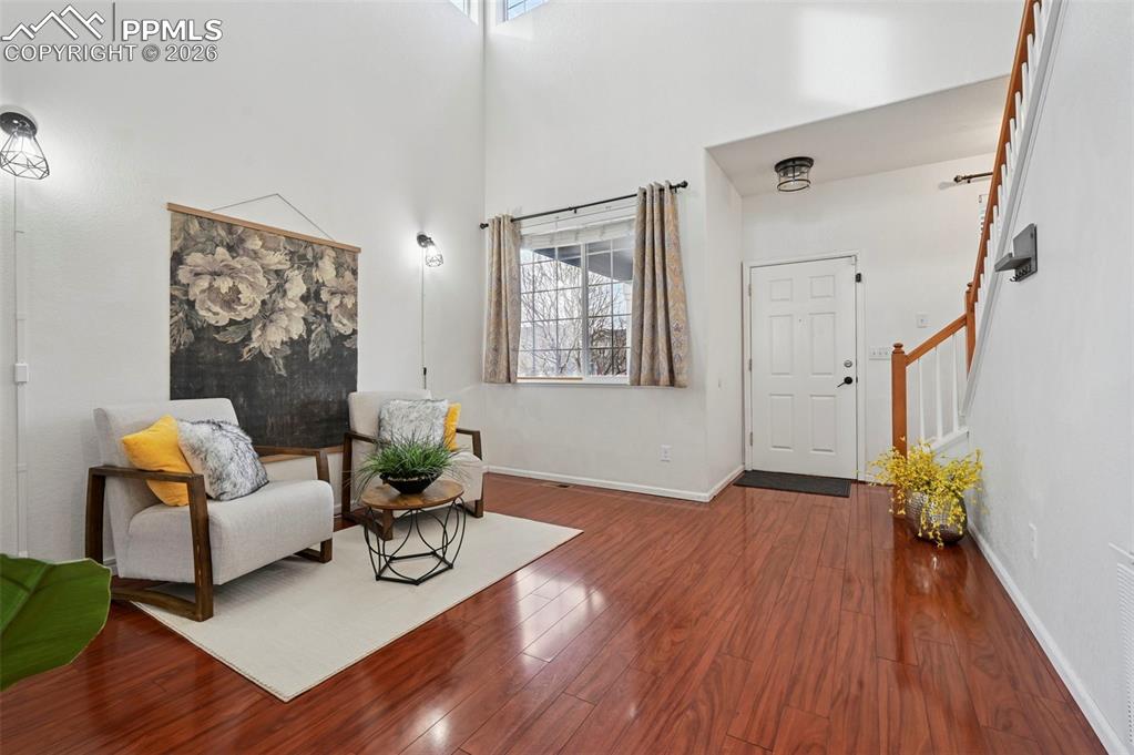 Image 4 of 49: Entry, vaulted ceiling, living room with double-sided gas fireplace