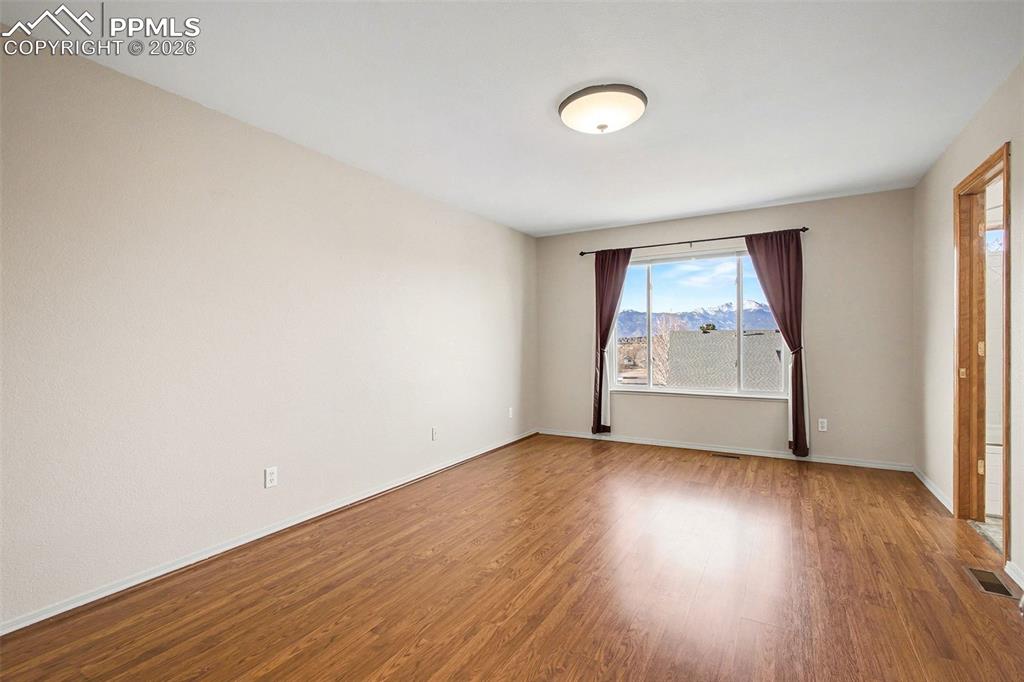 Image 14 of 28: Primary bedroom with mountain view