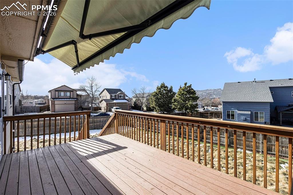 Image 2 of 28: Deck featuring a retractable awning
