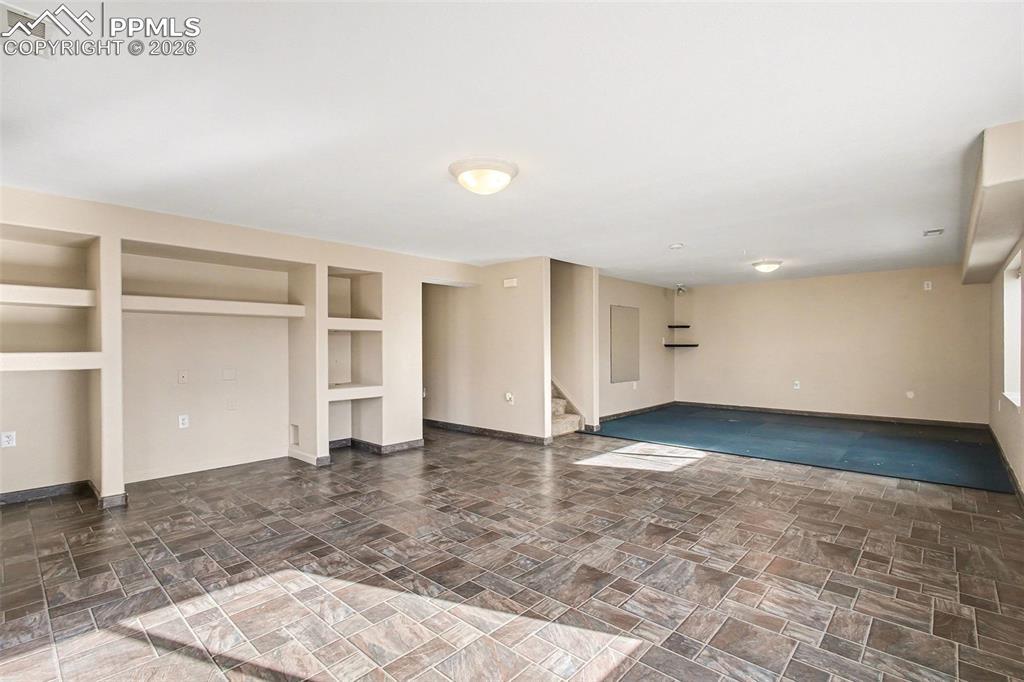 Image 21 of 28: Downstairs living room with walkout basement