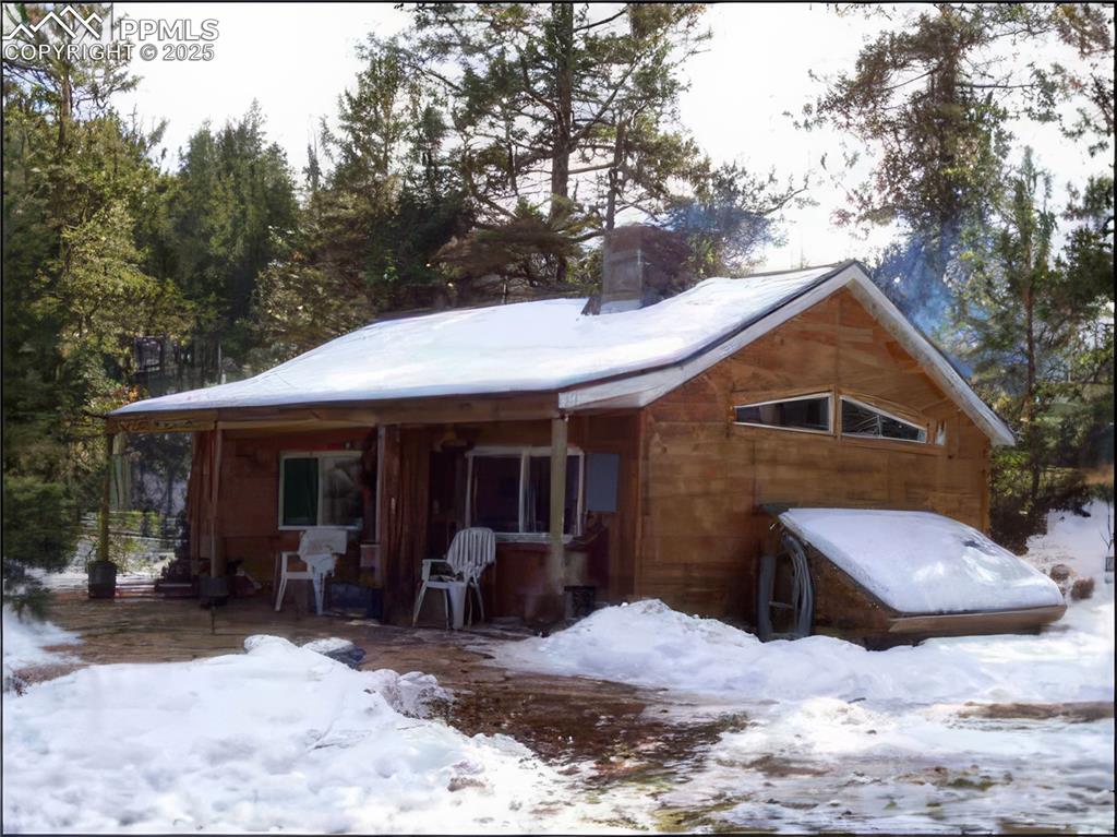 Image 47 of 47: Snow covered property featuring a chimney