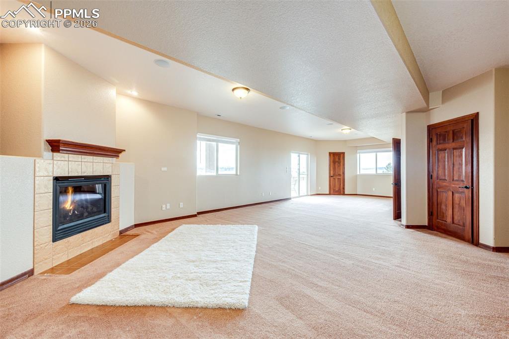 Image 34 of 49: Gas fireplace in walkout area