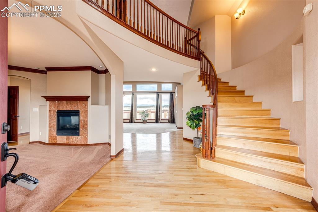 Image 5 of 49: Wood floor entry, Two way gas fireplace for Dining and Great rooms