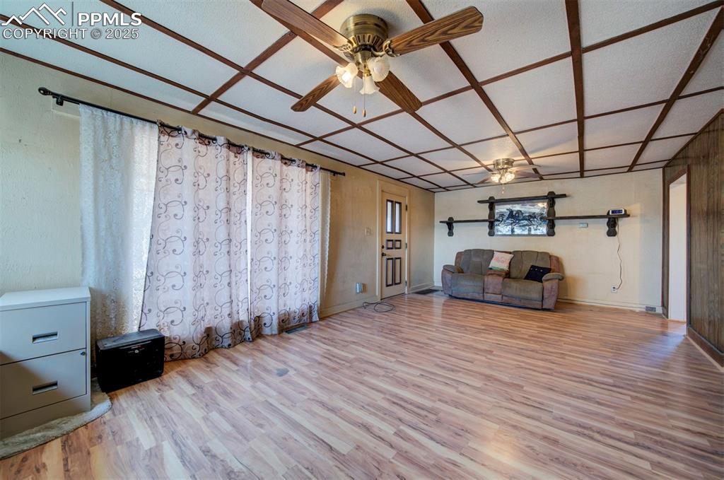 Image 5 of 22: Living room with large windows & great views of Pikes Peak.