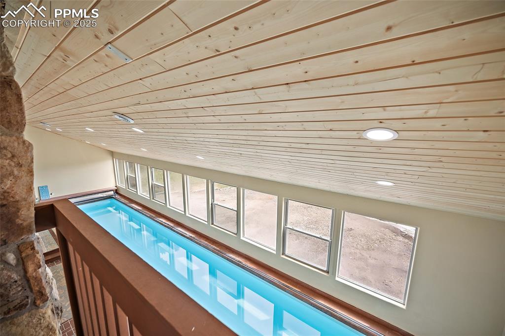Image 11 of 47: View of swimming pool with a hot tub from upstairs deck.