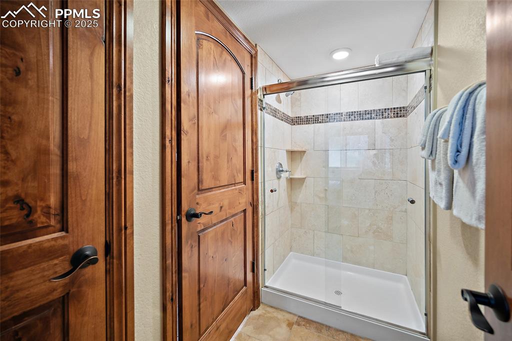 Image 25 of 47: Full bathroom with a stall shower