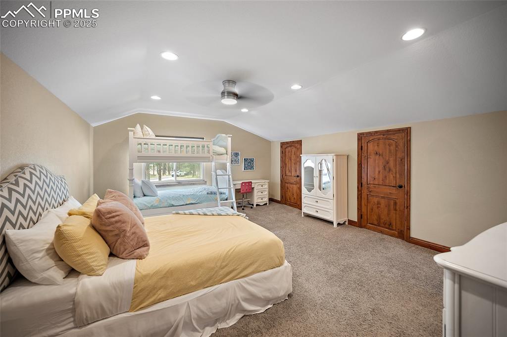 Image 35 of 47: Bedroom with vaulted ceiling, light carpet, recessed lighting, and ceiling