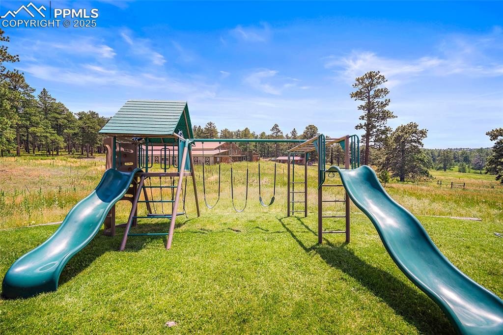 Image 41 of 47: Community jungle gym with a yard