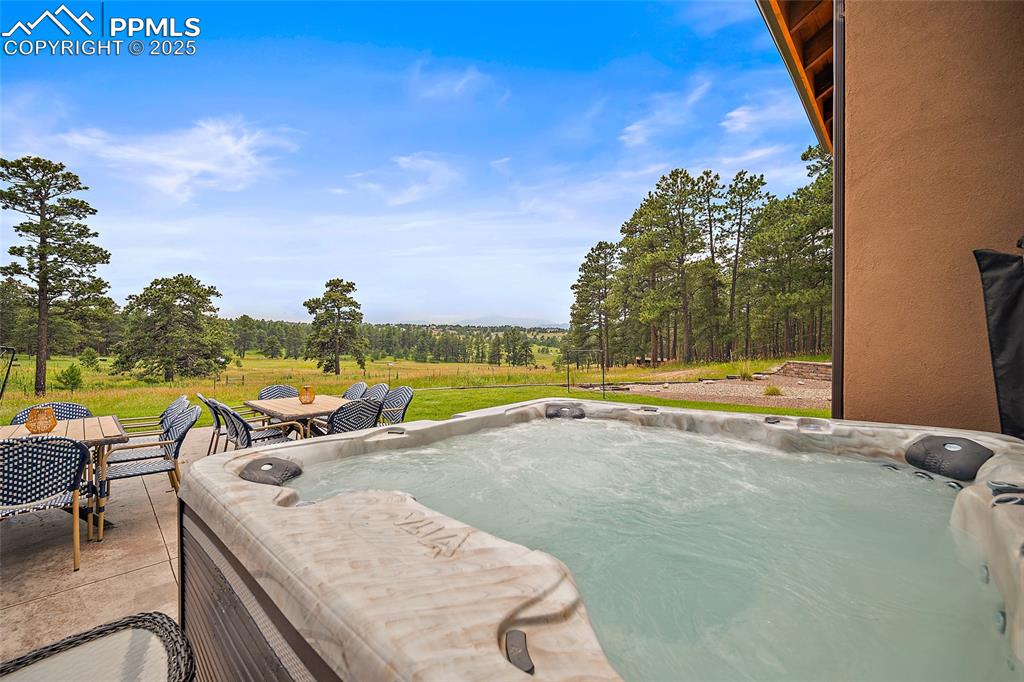 Image 43 of 47: View of pool with a hot tub and outdoor dining area