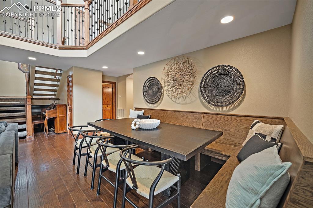 Image 9 of 47: Dining area with recessed lighting, stairs, hardwood / wood-style floors, a