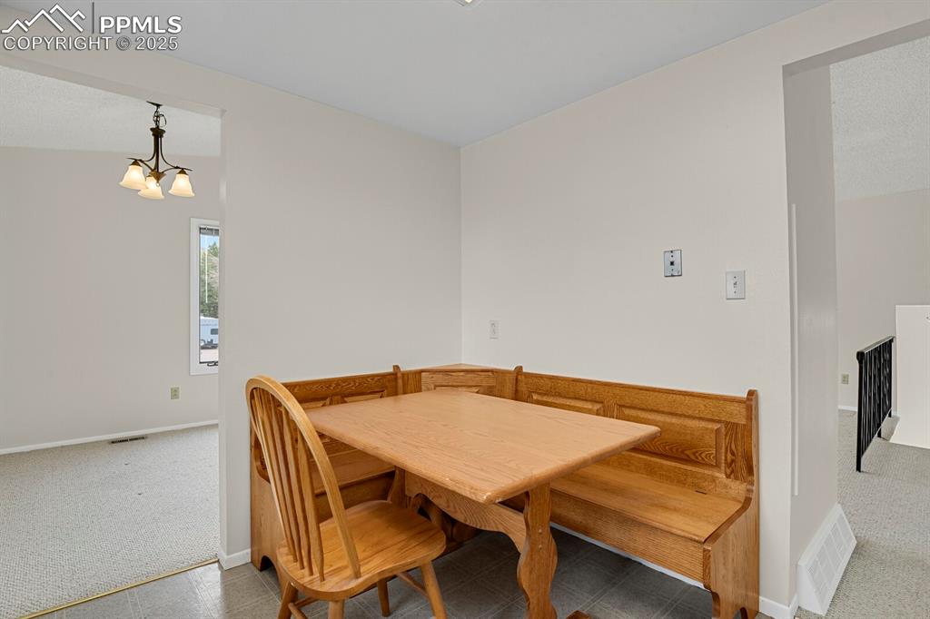 Image 16 of 45: Dining area featuring carpet floors and a chandelier