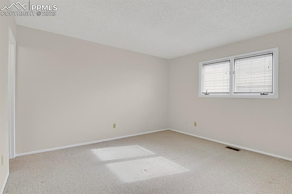 Image 19 of 45: Unfurnished room featuring carpet flooring and a textured ceiling