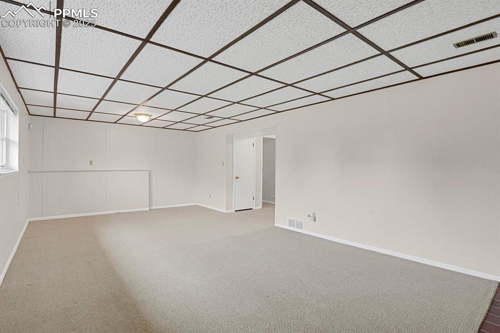 Image 29 of 45: Unfurnished room featuring carpet flooring and a drop ceiling