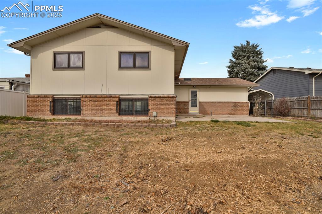 Image 40 of 45: Back of property featuring brick siding