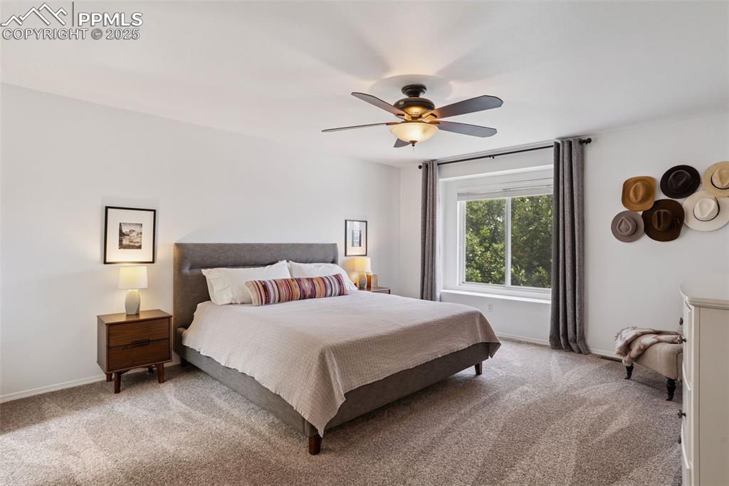 Image 17 of 40: Upstairs primary bedroom with baseboards and a ceiling fan