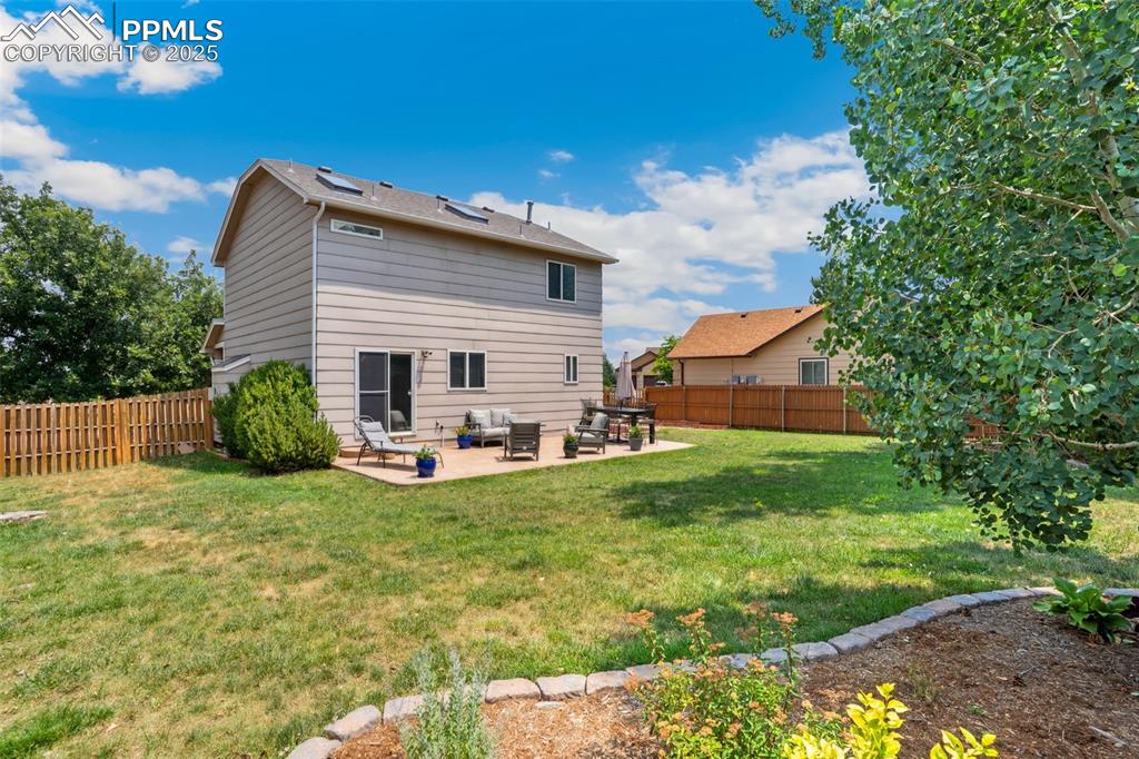 Image 35 of 40: Rear view of property featuring a patio, a fenced backyard, and outdoor lou