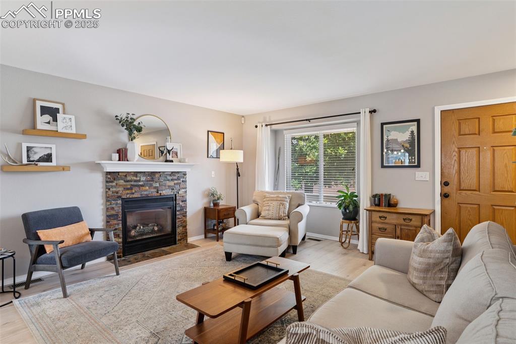 Image 4 of 40: Living room featuring LVP floors and a fireplace