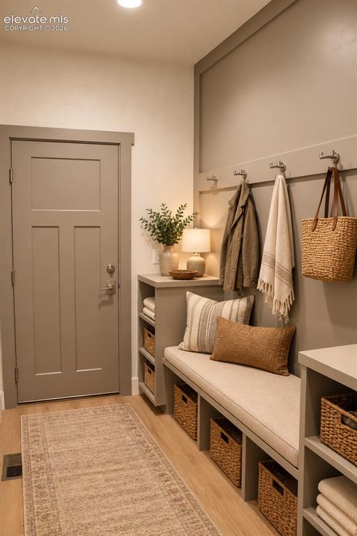 Image 19 of 44: Built-in bench with integrated storage cubbies, wall-mounted coat hooks, wo