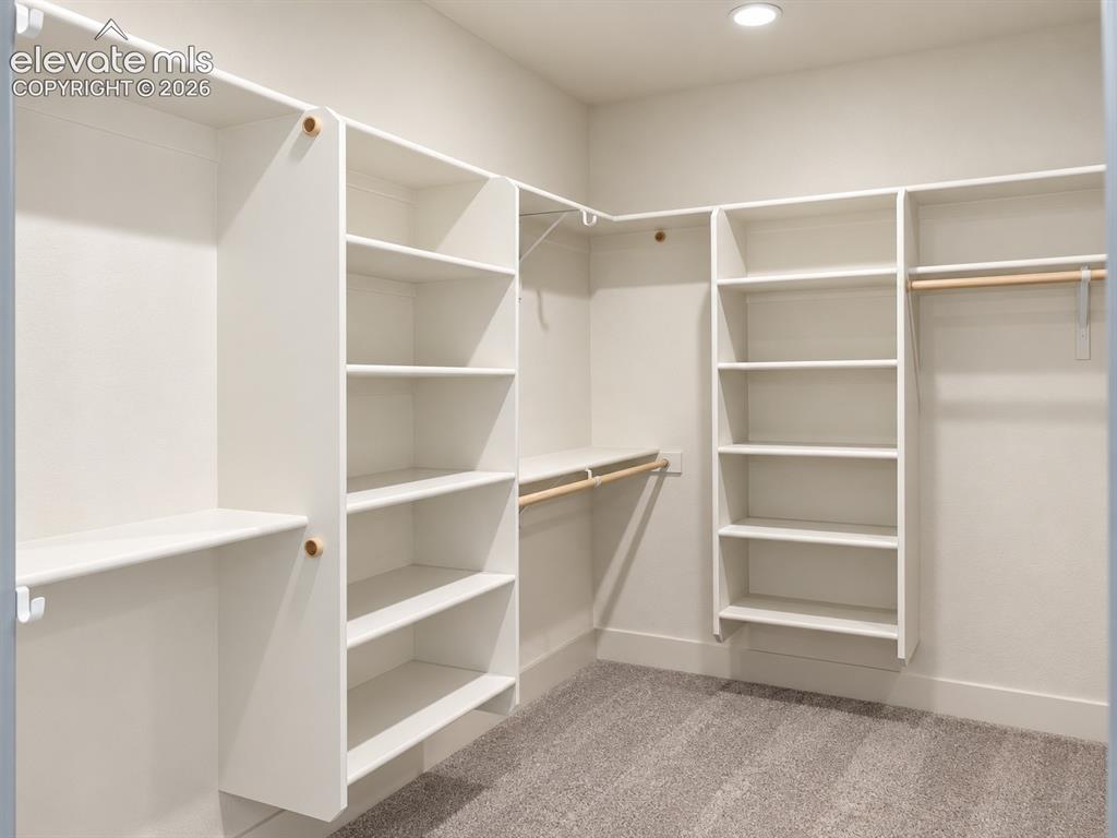 Image 31 of 44: Recessed ceiling lighting, white built-in shelving, natural wood finish han