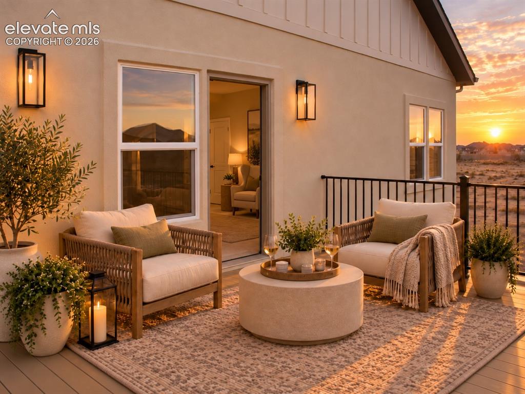 Image 32 of 44: Outdoor deck with wrought iron railing and sconce lighting