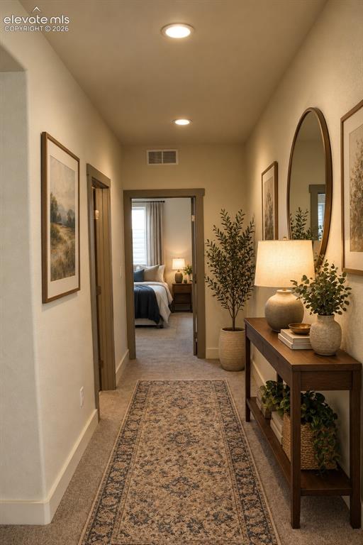 Image 40 of 44: Recessed ceiling lighting illuminates the hallway with neutral wall tones a