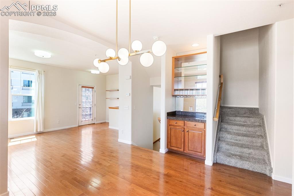 Image 8 of 34: Open to living room with dry bar 