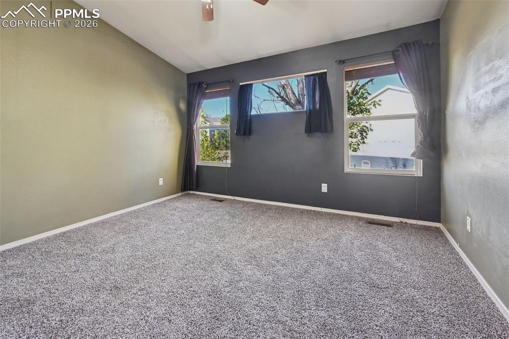 Image 17 of 35: Primary bedroom - Walls are white! Vaulted ceilings and lots of light