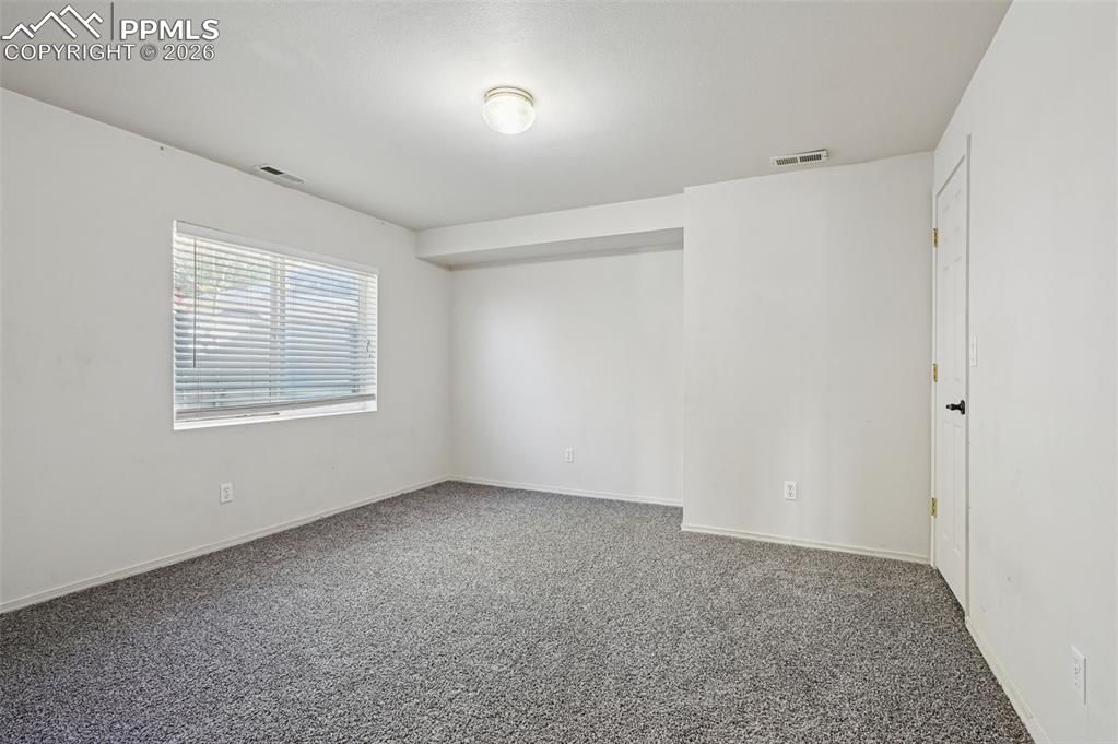 Image 25 of 35: 3rd bedroom (basement level) with walk-in closet, garden level